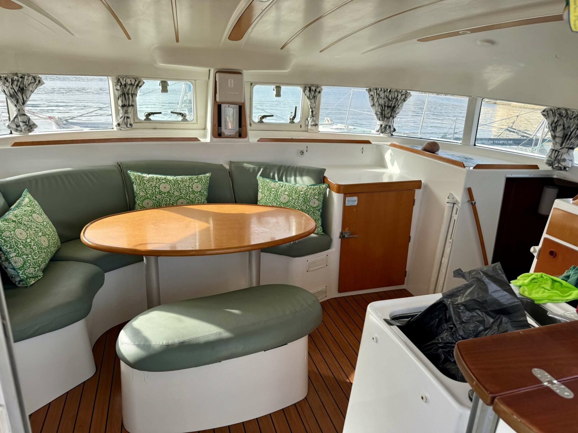 Interior salon seating and dining table aboard Cicciolina Mia catamaran
