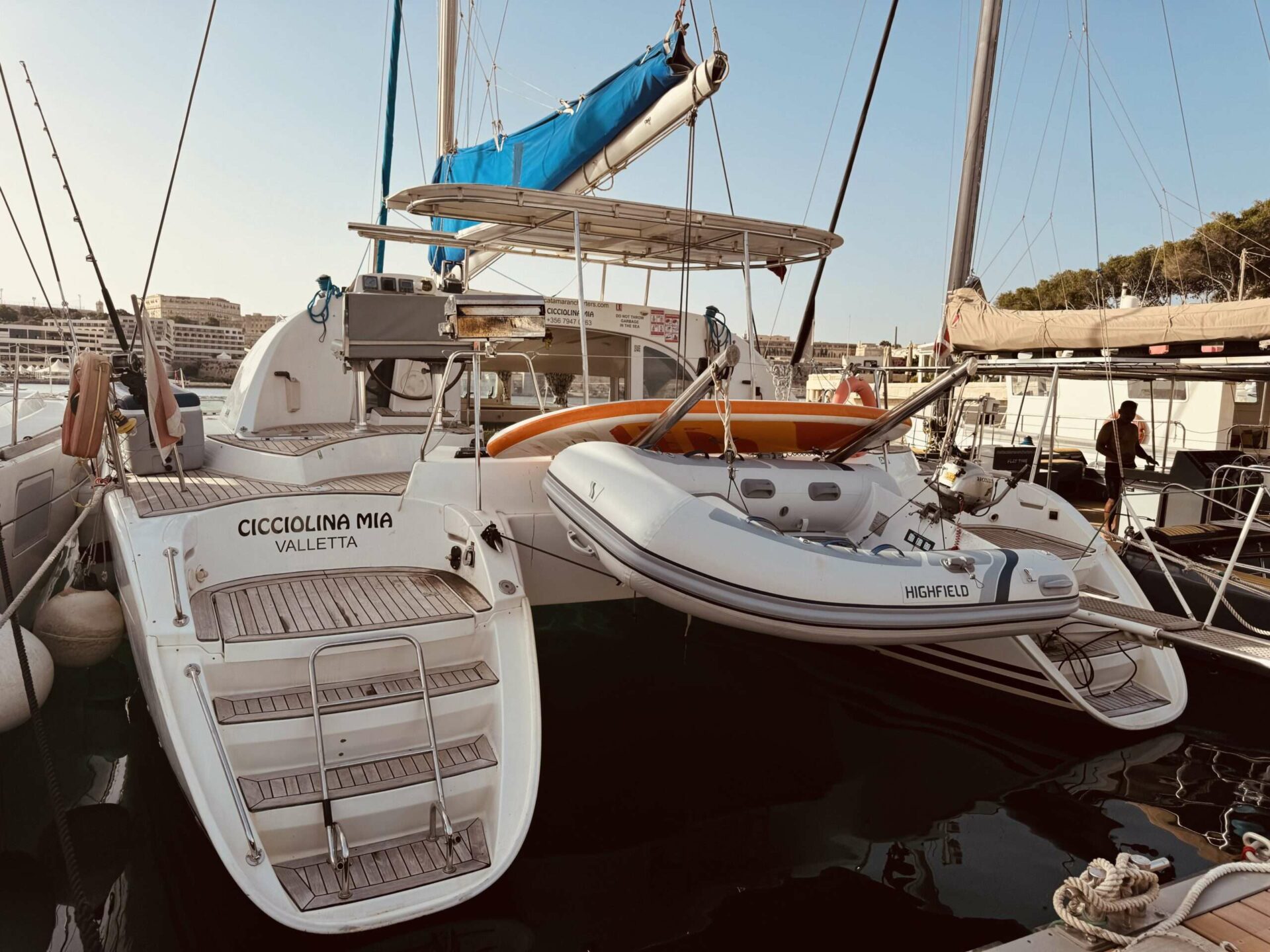 Rear view of Cicciolina Mia catamaran moored at Valletta marina, name plate visible