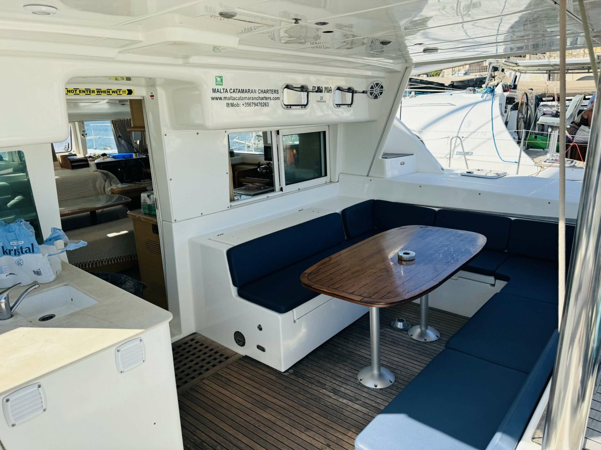 Outdoor cockpit dining area on Pupa Mia catamaran
