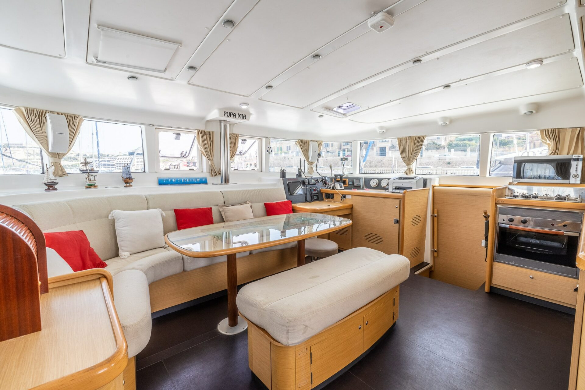 Pupa Mia catamaran's interior lounge seating and navigation station