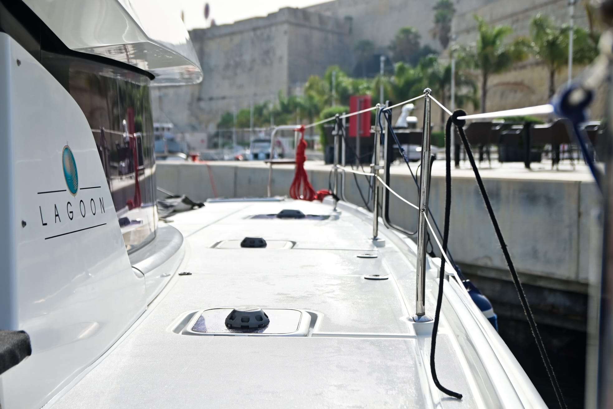 Lagoon logo on Bowie's hull, moored near Valletta's fortifications