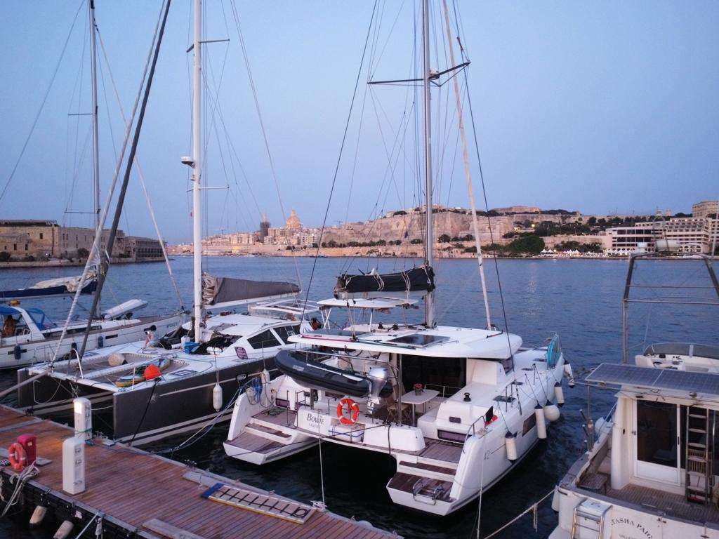 Bowie Lagoon 42 catamaran moored at dusk with Valletta's skyline in the background