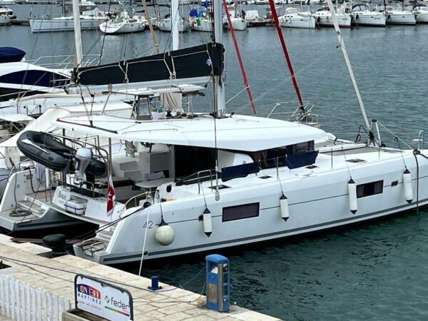 Bowie Lagoon 42 catamaran moored at a marina, name plate visible