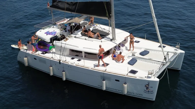 Guests sunbathing and swimming around Siesta Mia catamaran