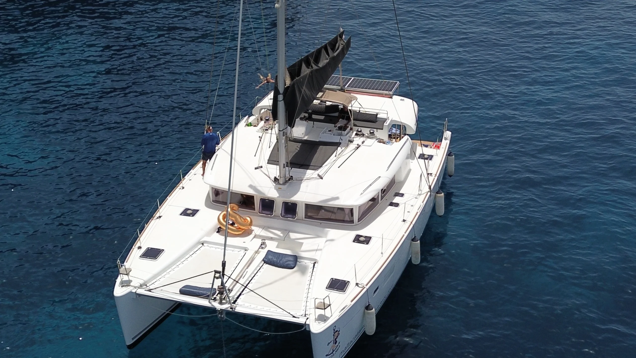 Aerial view of Siesta Mia catamaran anchored with a guest relaxing on deck