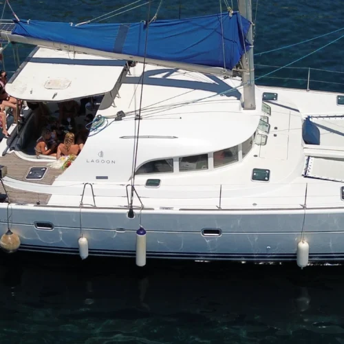 Cicciolina Mia catamaran anchored in clear Malta water with guests on deck