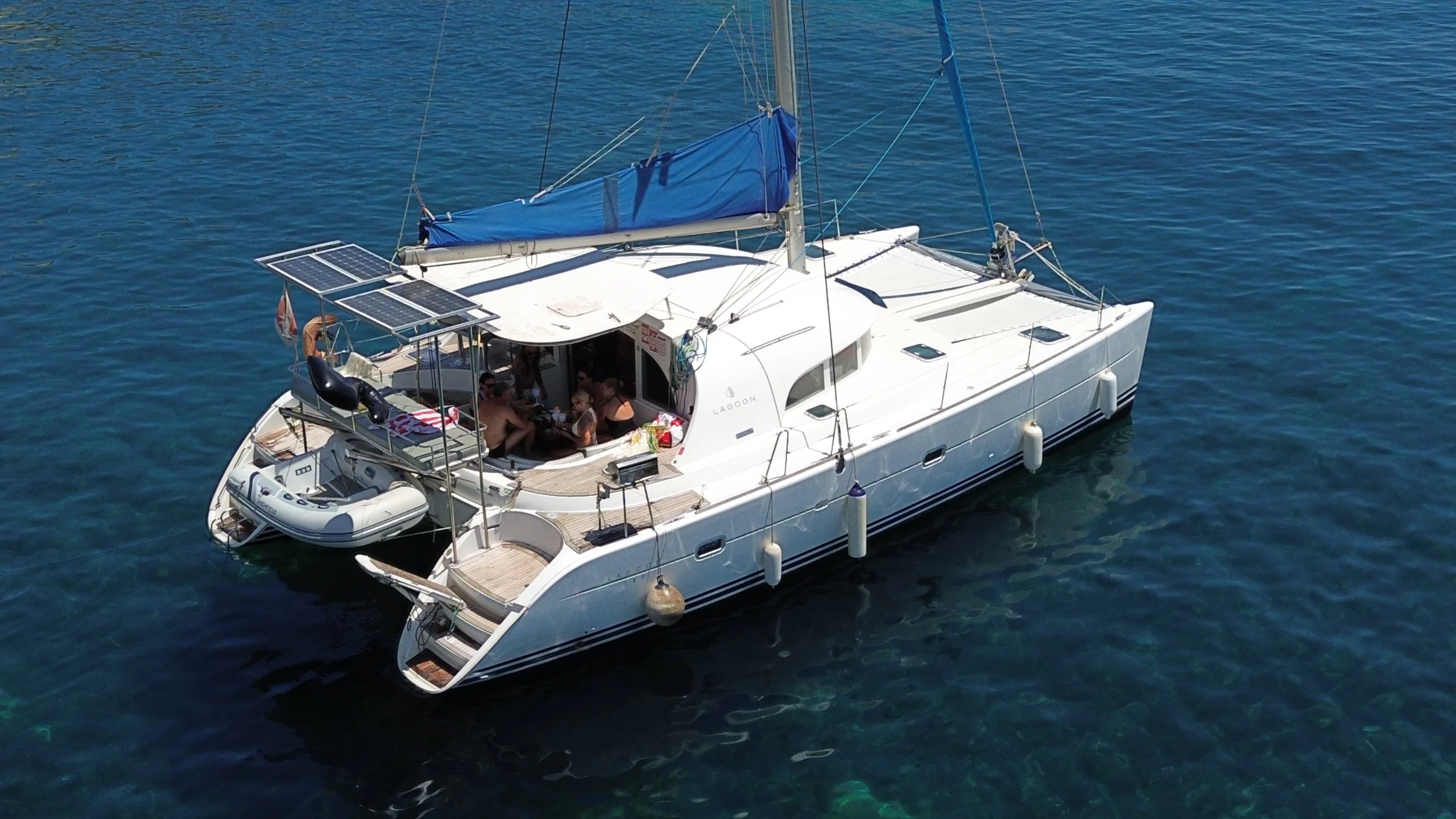 Cicciolina Mia catamaran anchored with guests relaxing in the cockpit